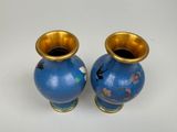 two vases that are sitting on a white surface