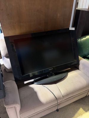 a flat screen tv sitting on a couch in a living room