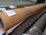 several rolls of carpet are stacked on top of each other in a warehouse