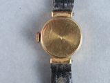 an image of a close up of a wrist watch on a table