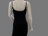the mannequin is wearing a black dress with a chain around the neck