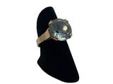 an image of a gold ring with a blue topaz stone on it