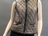 an image of a mannequin wearing a quilted vest and skirt