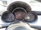 a close up of a car dashboard with gauges and speedometers
