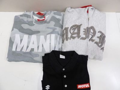 two t - shirts that are sitting on a table