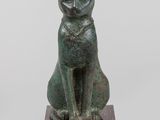 an image of a statue of a cat sitting on top of a block