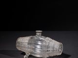 a clear glass container with a lid on a black surface