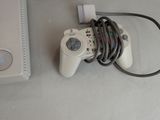 a video game controller sitting next to a laptop