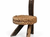 a wooden chair with a woven seat on a white background