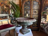 a large vase sitting on a pedestal in a room
