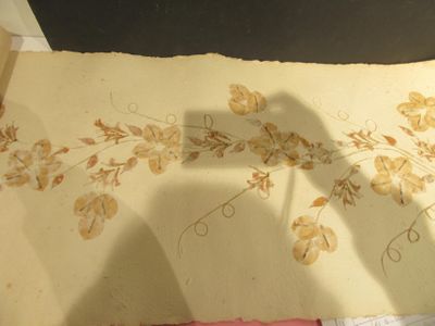 a person standing next to a piece of paper with a drawing of flowers on it