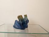 a glass table with a blue vase on top of it