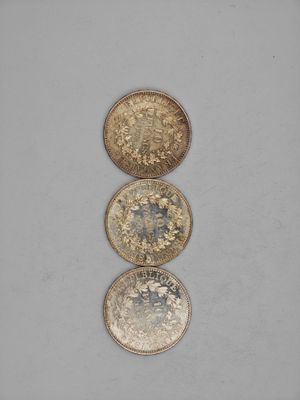 three different types of coins sitting on top of each other