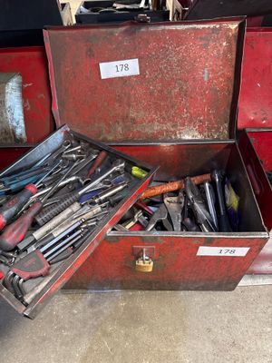 many tools in a red toolbox on the floor