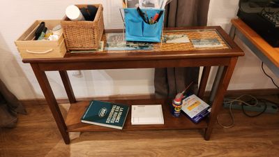 a small table with a book and a bag on it
