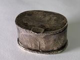 a silver box sitting on top of a white surface