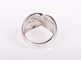a close up of a diamond ring on a white surface