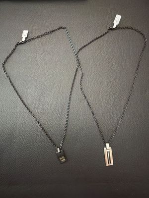 a couple of necklaces that are sitting on top of a table