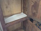 a wooden cabinet with a door open on a wooden floor