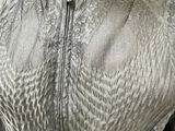 a mannequin wearing a silver dress on a mannequin stand