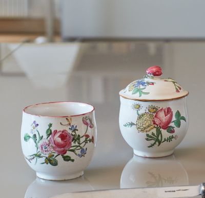 two cups and a spoon sitting on a table
