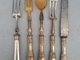 five different types of silverware on a table