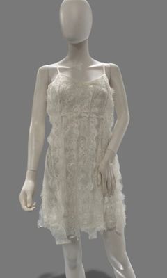 a mannequin dressed in a white dress on display
