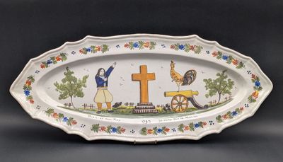 an oval platter with a picture of a woman and a cross on it