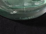 a glass sculpture of a man sitting on a chair