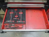 a red tool box with tools inside of it