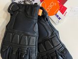 a pair of black leather gloves on a white table