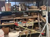 a pile of junk in a garage with a cart full of stuff