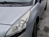 a silver car that is parked in a parking lot