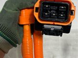 someone is holding an orange and black power cord in their hand