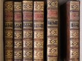 a box full of old books sitting on top of a table