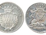 four different types of silver coins are shown on a white background