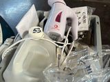 a plastic container filled with items that include a hair dryer and other items