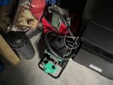 a pile of luggage sitting on the floor next to a metal cabinet