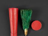 two red and green paper cups and a green brush on a black surface