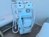 a small room with a bed and a machine in it