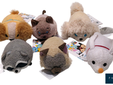 five stuffed animals that are sitting on a white surface