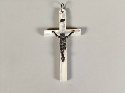 a cross with a crucif on it hanging on a wall