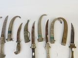 a lot of different types of knives on the wall