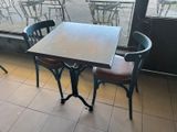 a table and chairs in a restaurant with a view of the street