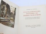 someone is holding a book with a picture of a building in it