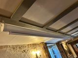 a picture of a room with a window and a ceiling fan