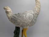 a statue of a bird that is standing on a rock
