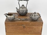 three pieces of silverware sitting on top of a wooden box