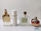three different perfume bottles sitting next to each other on a table