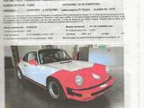 an image of a red and white car is parked in a garage